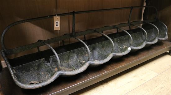A wrought iron seven stall sheep trough, and a pair of iron firedogs (3) trough W.150cm